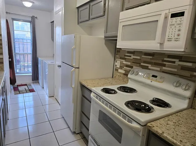 a kitchen with a stove and a refrigerator