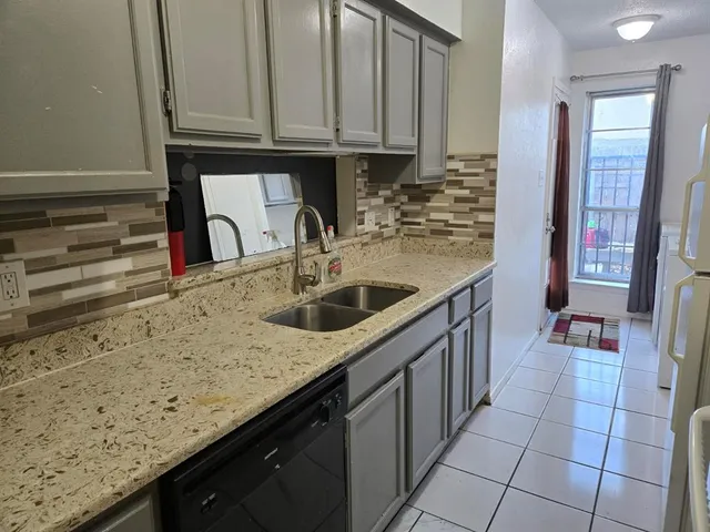 a kitchen with stainless steel appliances granite countertop a sink and cabinets