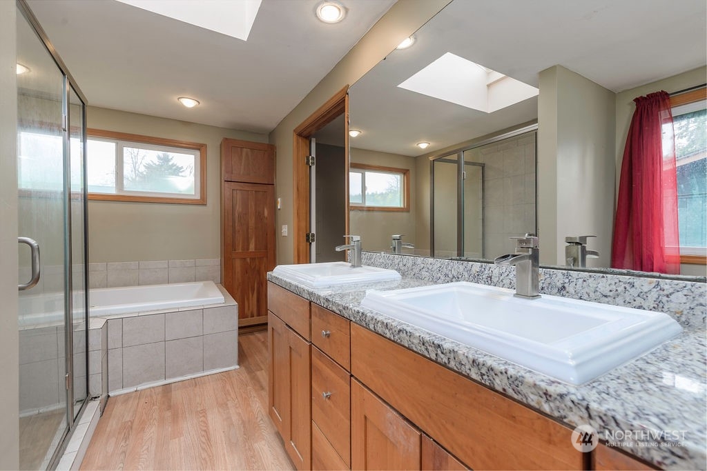 501 River Road Chehalis, WA 98532 - Photo 13 of 27 a bathroom with a granite countertop sink a mirror and a bathtub