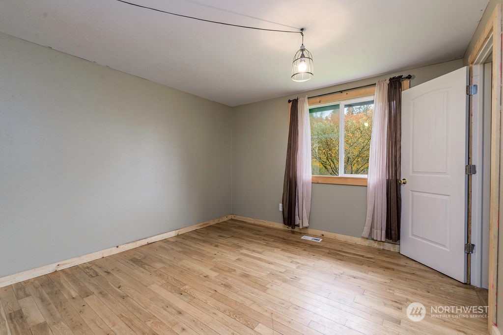 501 River Road Chehalis, WA 98532 - Photo 14 of 27 a view of an empty room with wooden floor and a window