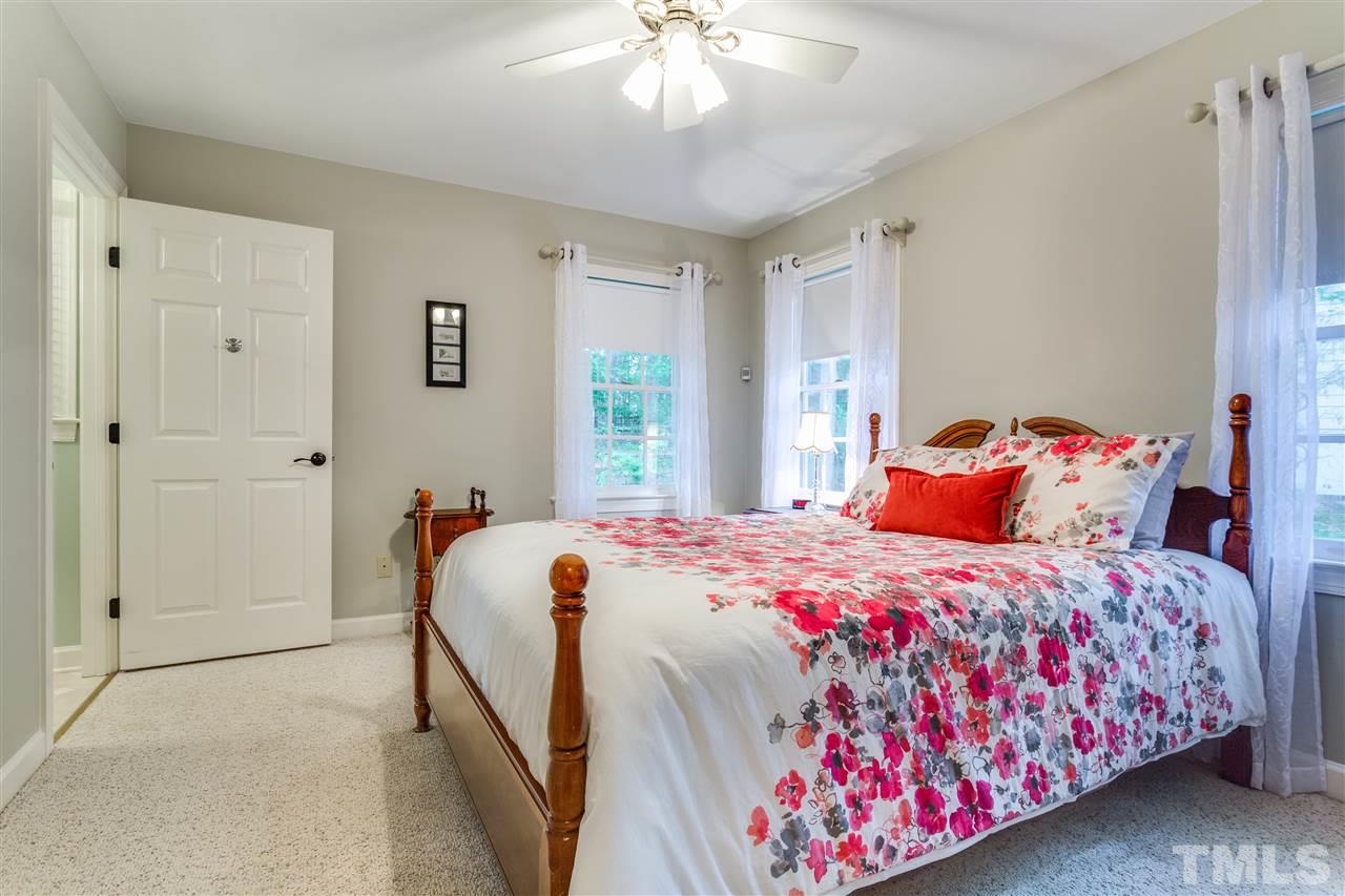 2020 Torrington Street Raleigh, NC 27615 - Photo 14 of 25 a bedroom with a bed and a chandelier