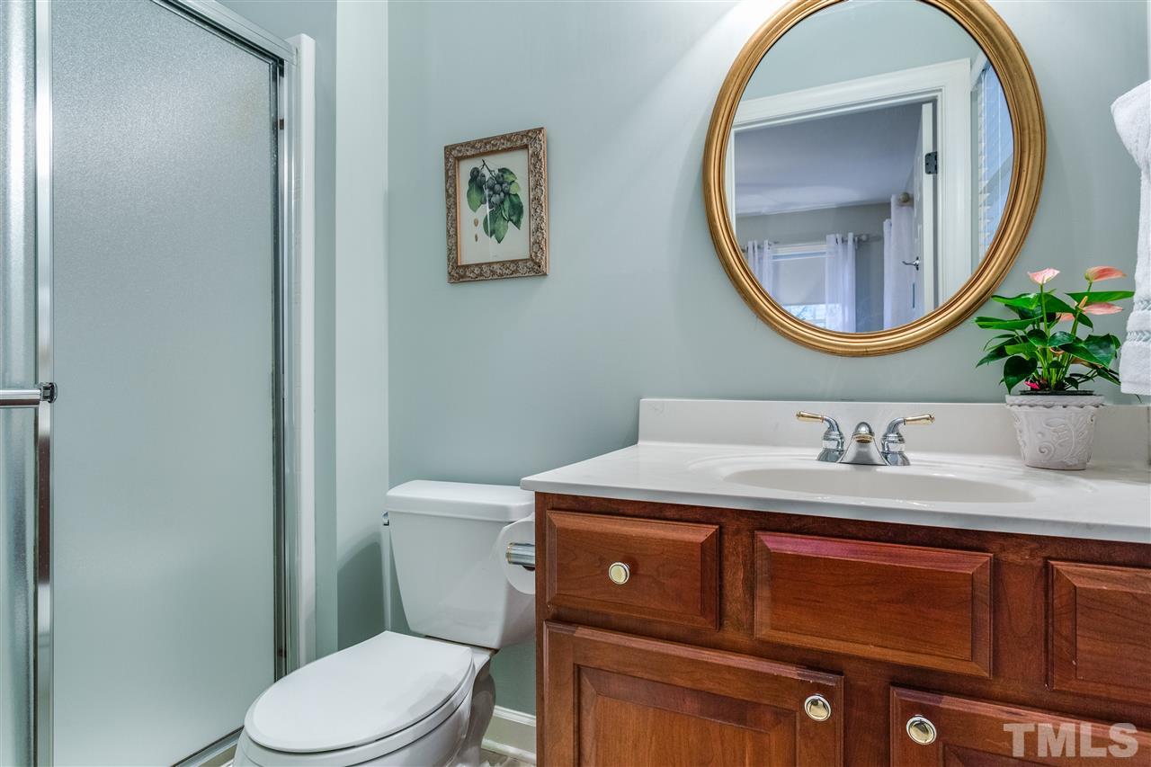 2020 Torrington Street Raleigh, NC 27615 - Photo 15 of 25 a bathroom with a toilet a sink and a mirror