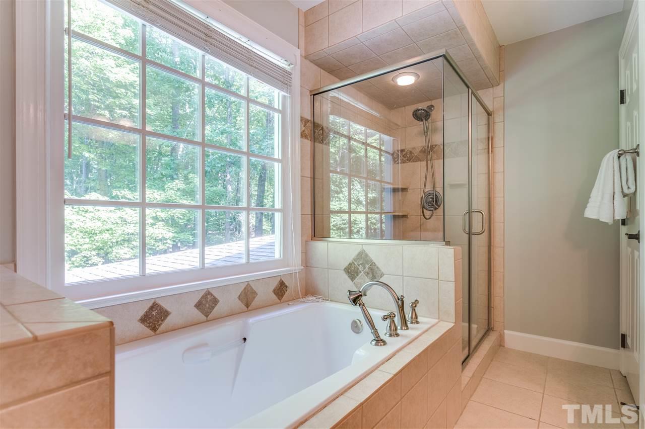 2020 Torrington Street Raleigh, NC 27615 - Photo 18 of 25 a bathroom with a tub a sink and a large window