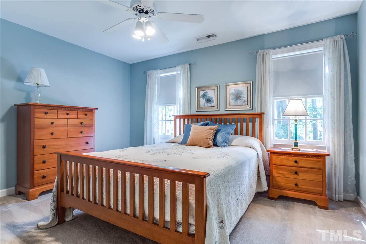 2020 Torrington Street Raleigh, NC 27615 - Photo 19 of 25 a bedroom with a bed and a chandelier