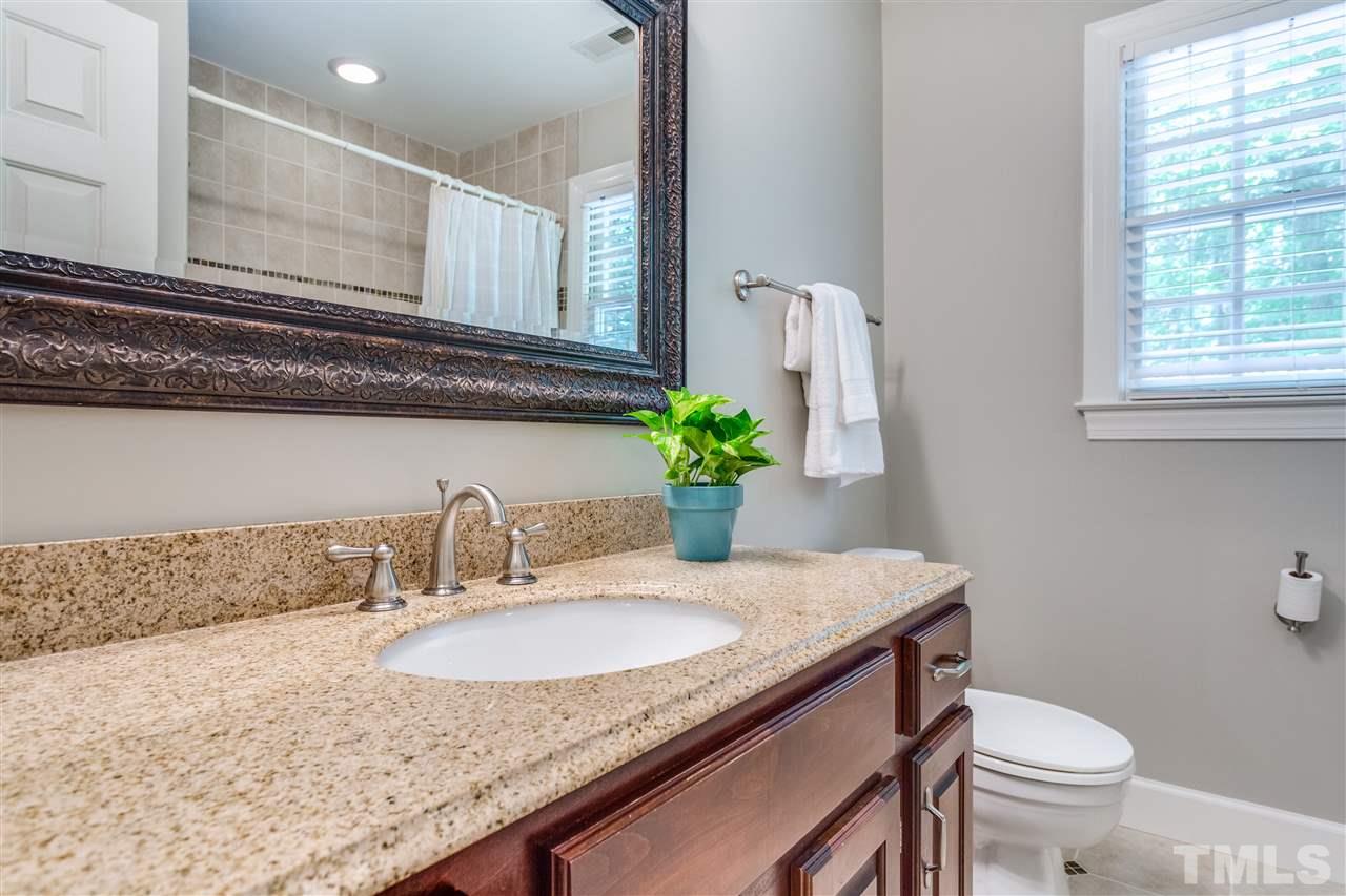 2020 Torrington Street Raleigh, NC 27615 - Photo 20 of 25 a bathroom with a granite countertop sink a toilet and mirror