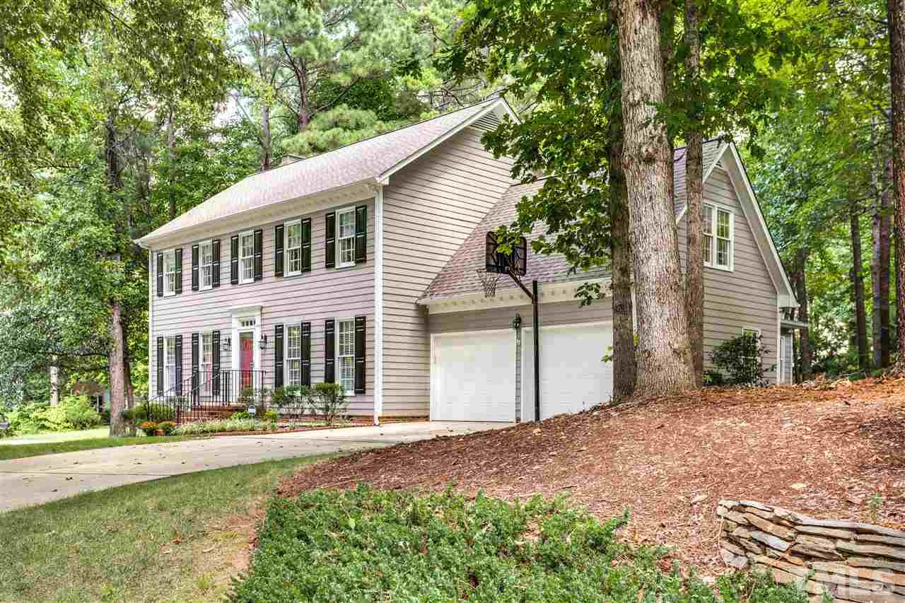 2020 Torrington Street Raleigh, NC 27615 - Photo 3 of 25 a front view of a house with a garden and trees