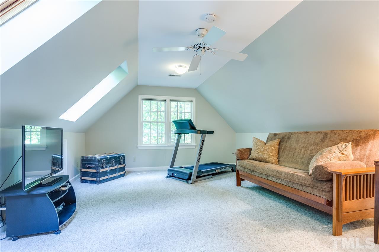 2020 Torrington Street Raleigh, NC 27615 - Photo 21 of 25 a living room with furniture gym equipment and a window
