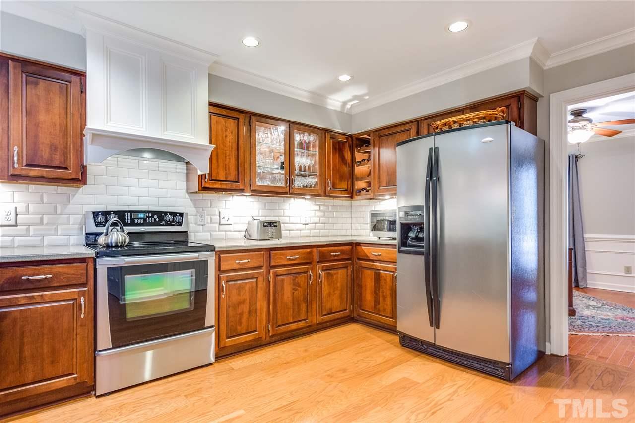 2020 Torrington Street Raleigh, NC 27615 - Photo 7 of 25 a kitchen with stainless steel appliances granite countertop a refrigerator a stove top oven and sink