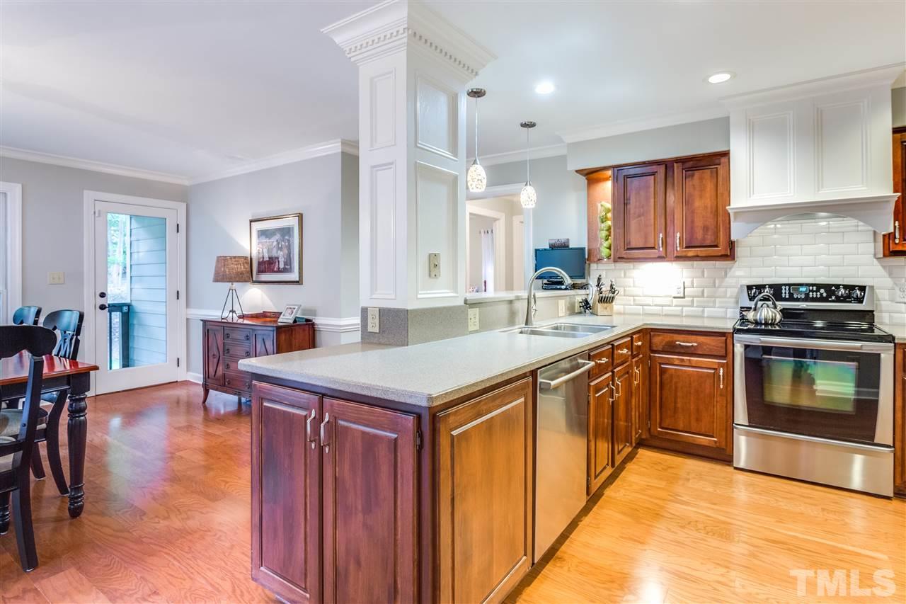 2020 Torrington Street Raleigh, NC 27615 - Photo 8 of 25 a kitchen with a stove a sink and a refrigerator
