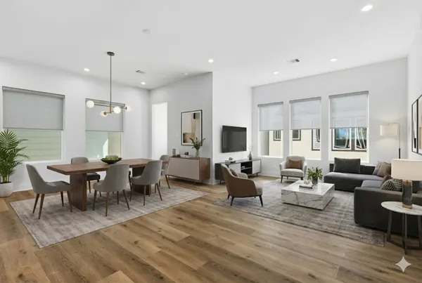 a large kitchen with stainless steel appliances sink a large window and wooden floor