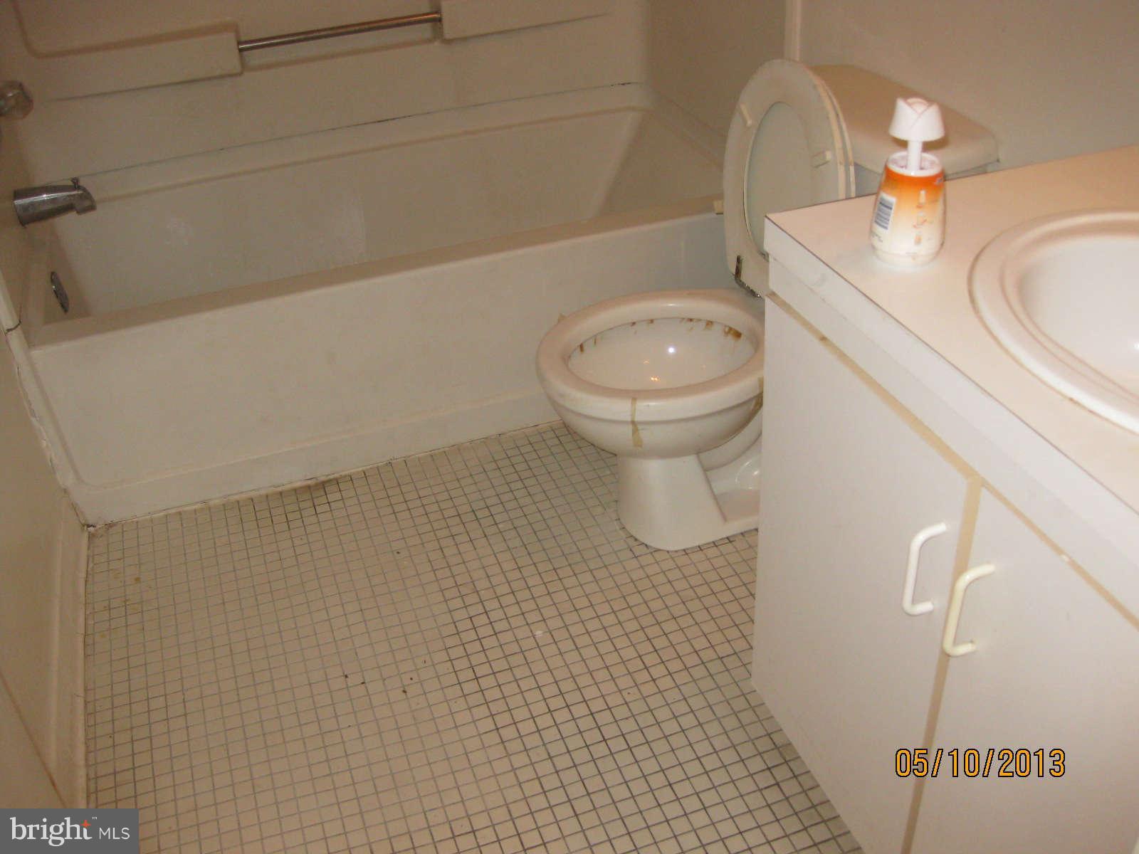 512 Charles Street, Unit R90 Baltimore, MD 21201 - Photo 6 of 10 a bathroom with a sink a toilet and shower