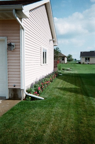 220 Willis Avenue Rochelle, IL 61068 - Photo 23 of 25 a front view of a house with a garden