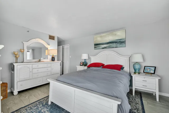 a view of a bedroom with a bed and a dresser