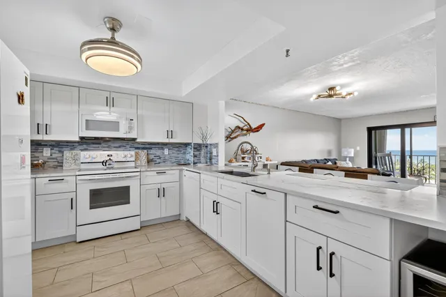 a kitchen with a sink stove and cabinets