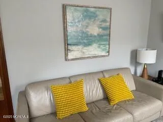 a view of a bedroom with furniture and wooden floor