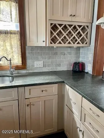 a kitchen with stainless steel appliances granite countertop a sink and a wooden cabinets
