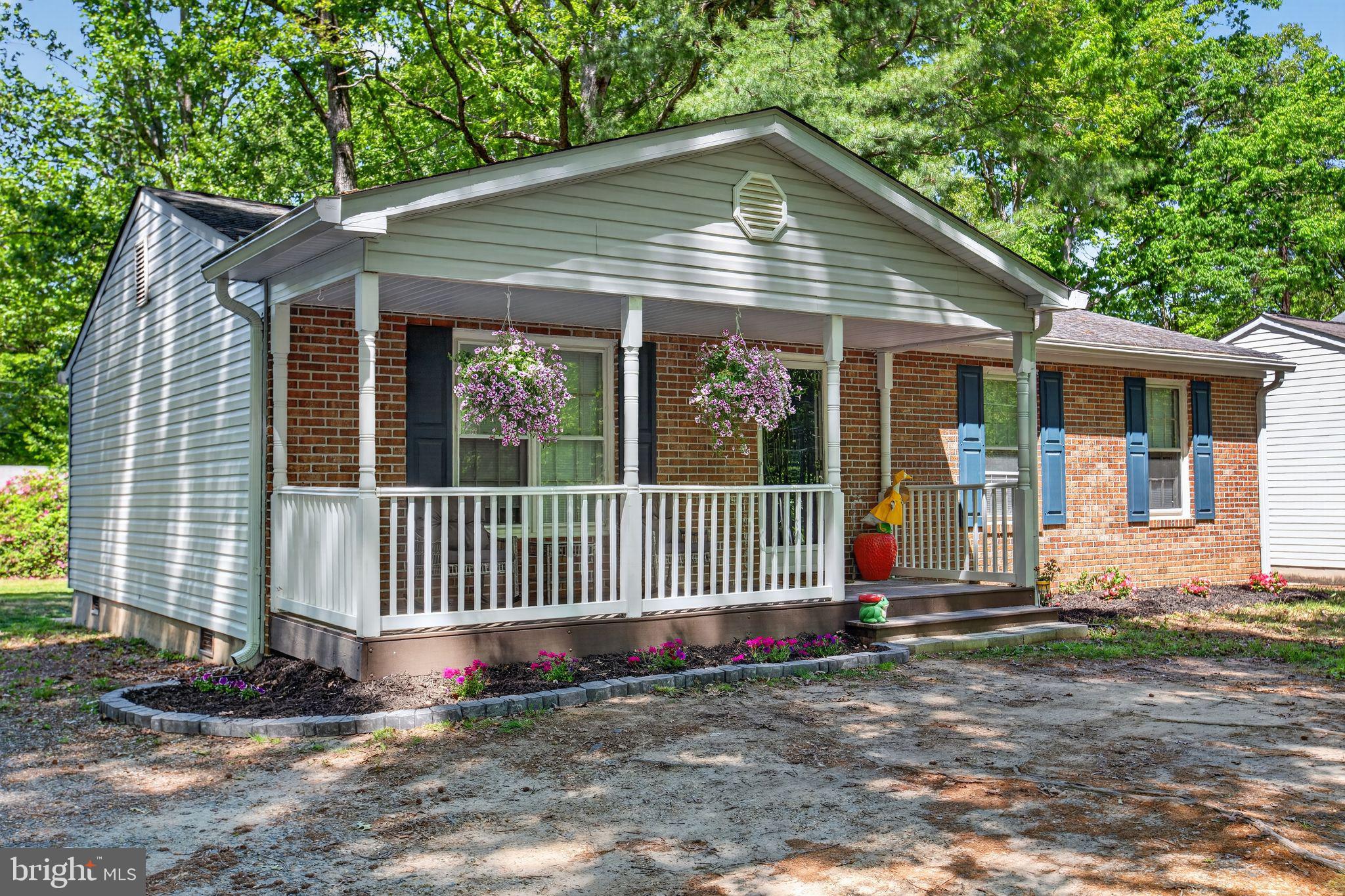 11789 Little Cove Point Road Lusby, MD 20657 - Photo 2 of 16 a front view of a house with a garden