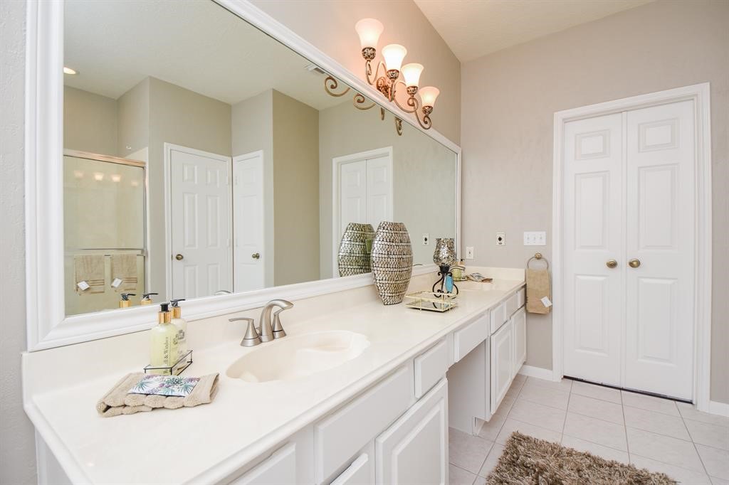 27 West Rumple Creek Place Spring, TX 77381 - Photo 17 of 32 The primary ensuite bathroom showcases a large spa-like bathroom.