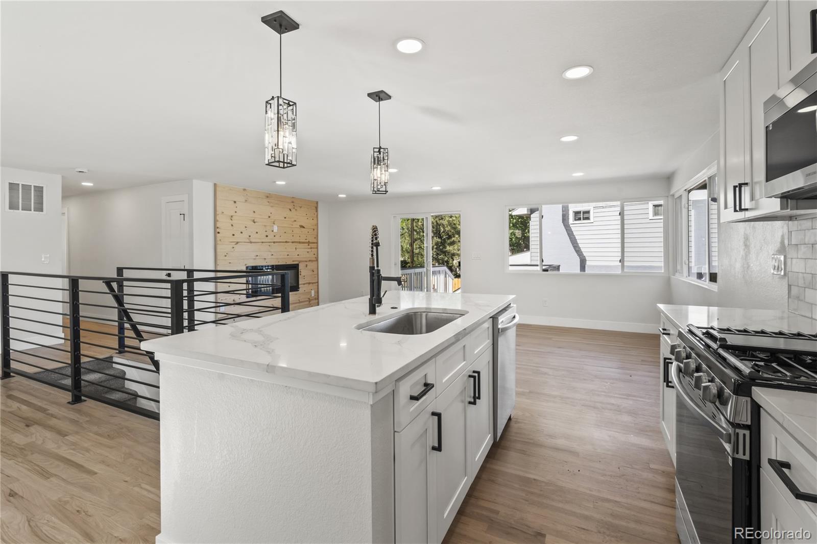 3495 Miller Street Wheat Ridge, CO 80033 - Photo 11 of 40 a kitchen with stainless steel appliances a sink and stove