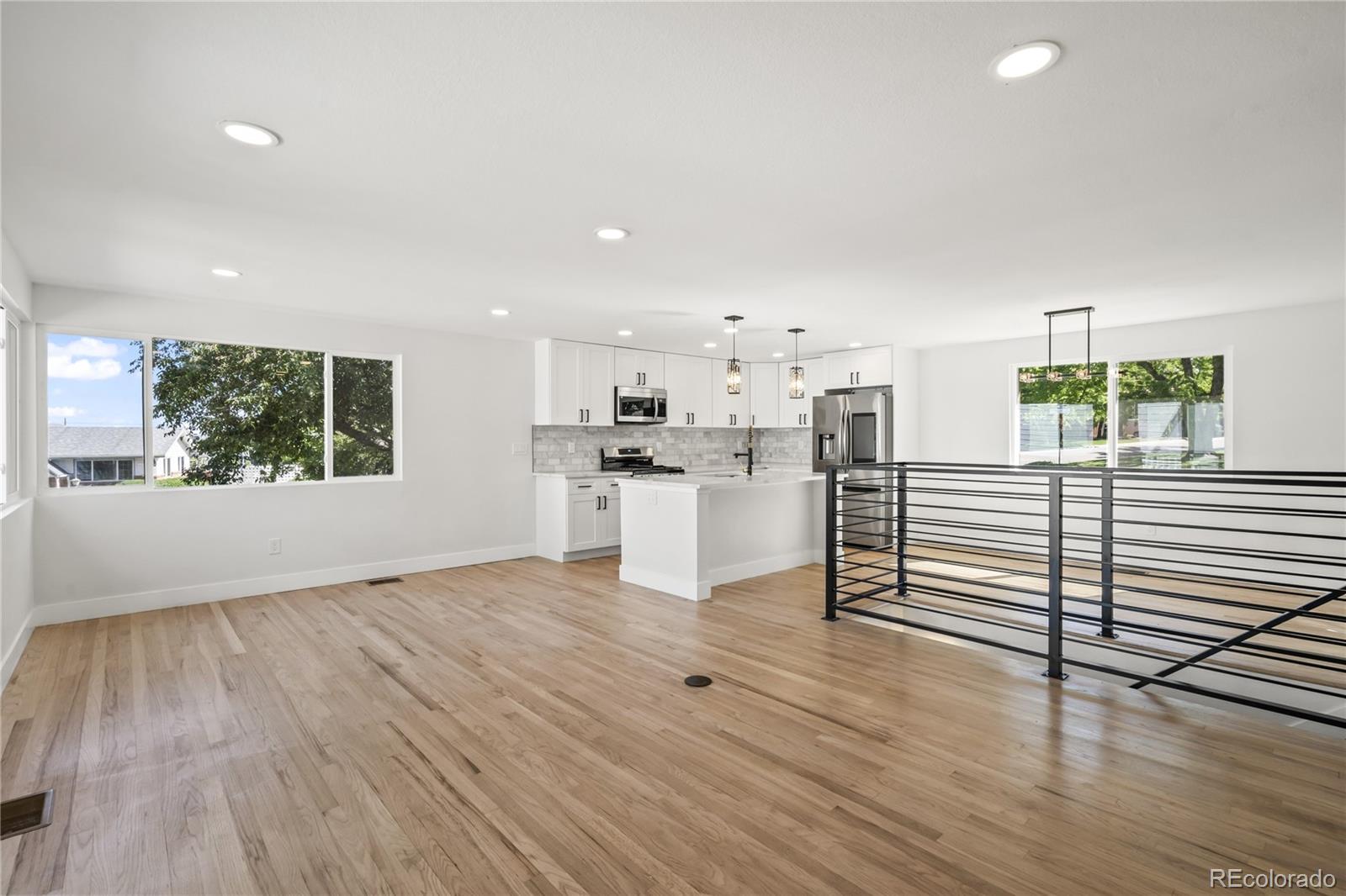 3495 Miller Street Wheat Ridge, CO 80033 - Photo 15 of 40 a view of a kitchen with wooden floor and electronic appliances