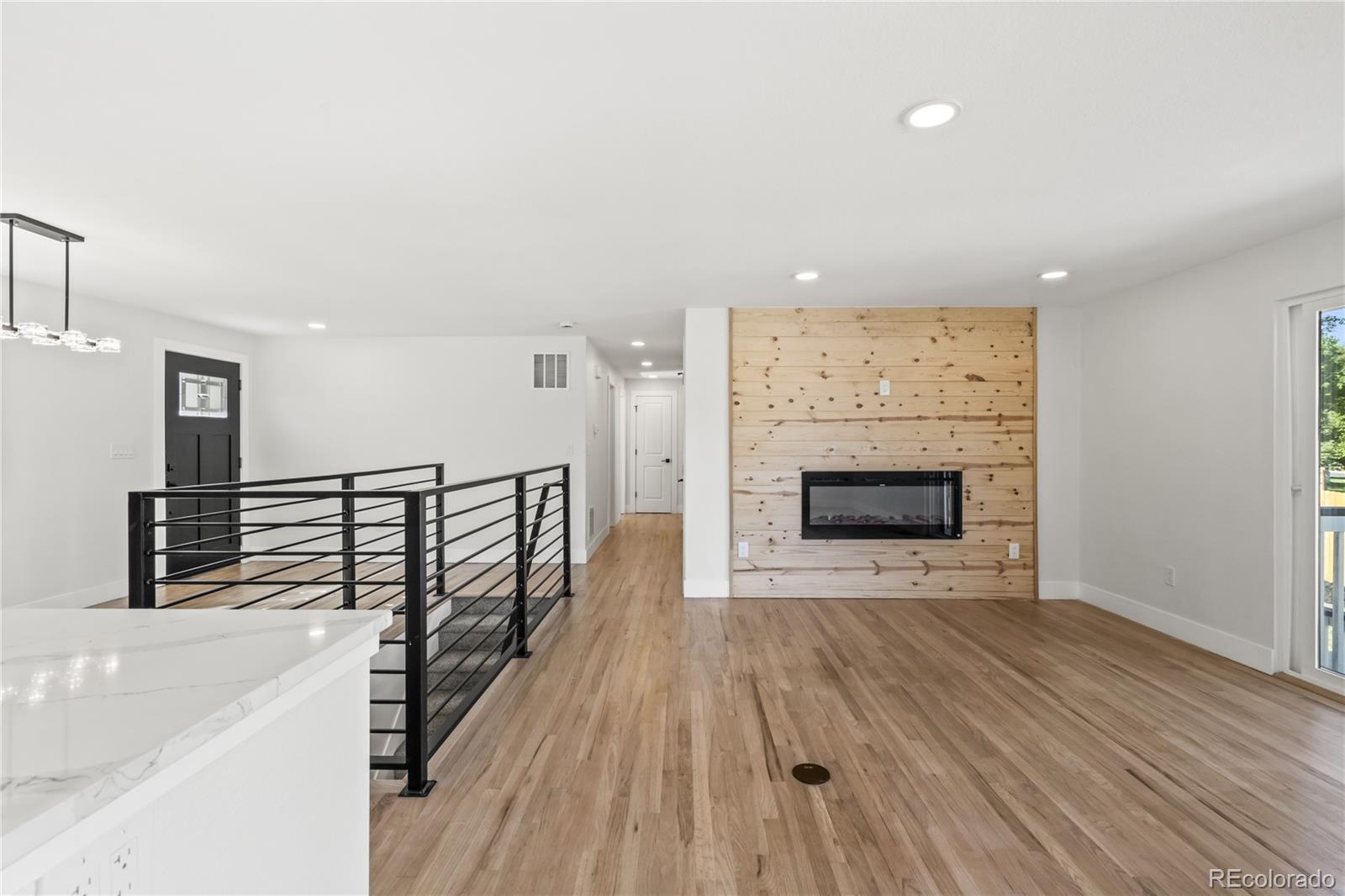 3495 Miller Street Wheat Ridge, CO 80033 - Photo 16 of 40 a view of a livingroom with wooden floor and fireplace