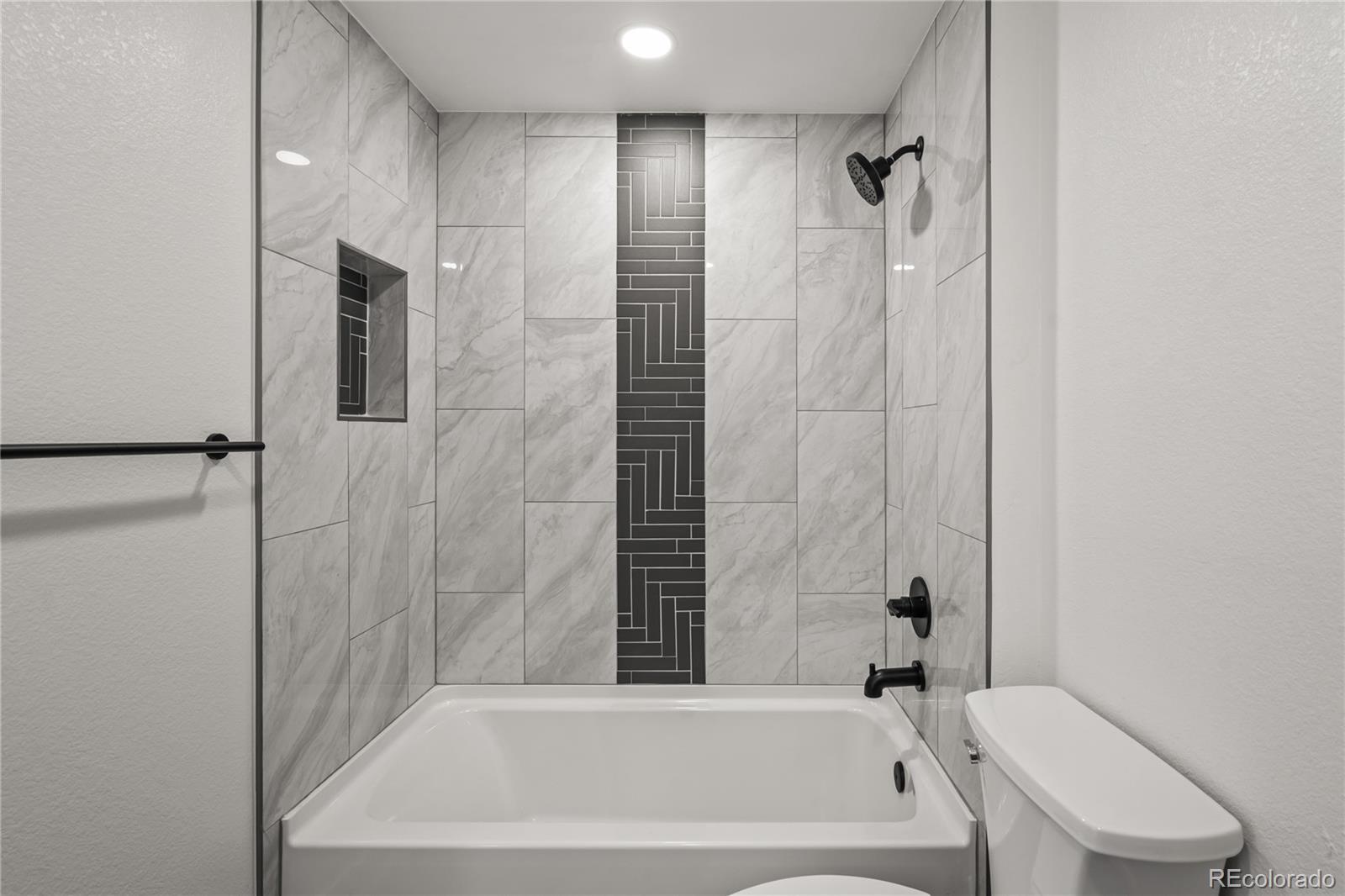 3495 Miller Street Wheat Ridge, CO 80033 - Photo 18 of 40 a bathroom with a bathtub and a shower