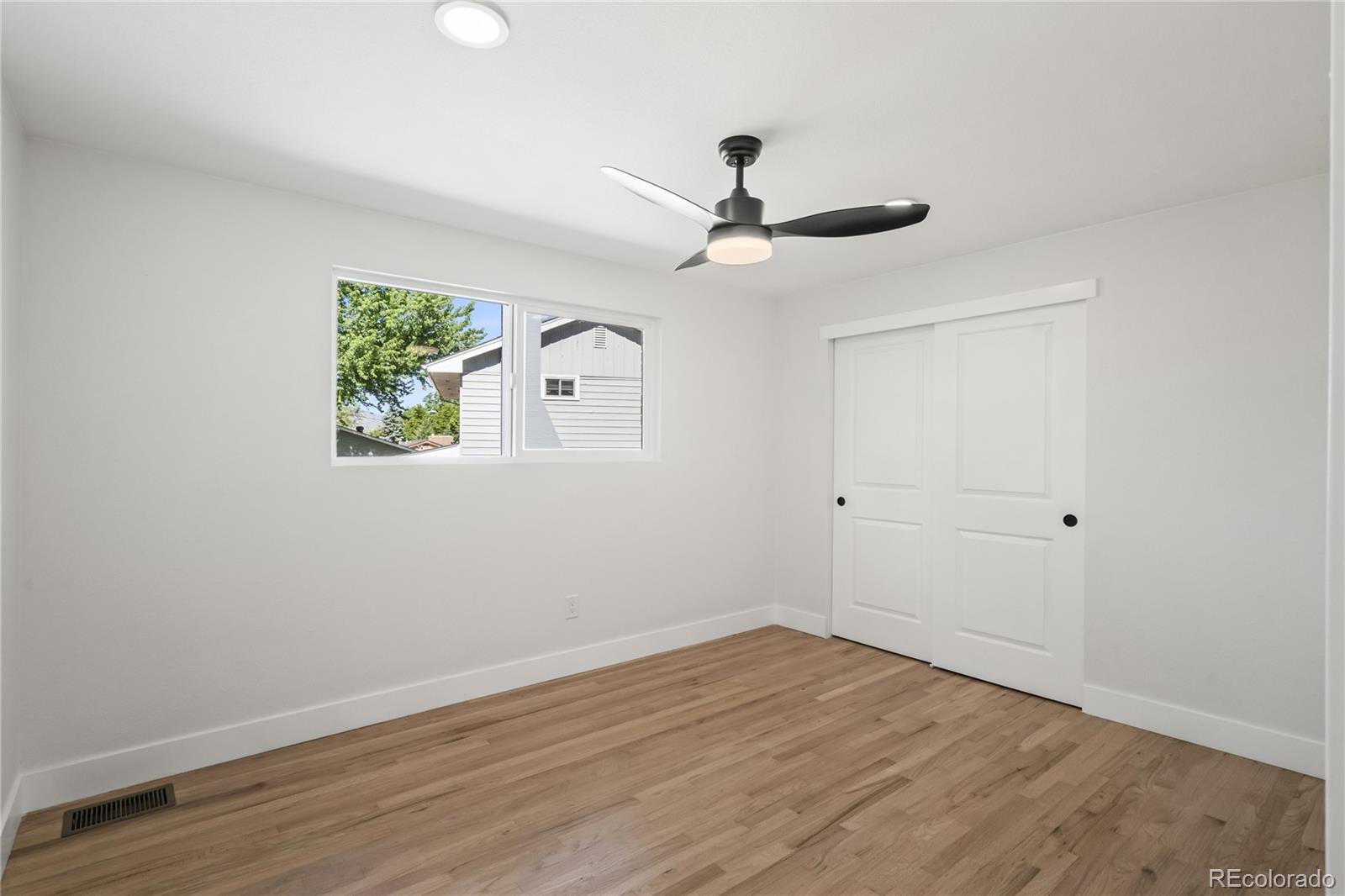 3495 Miller Street Wheat Ridge, CO 80033 - Photo 19 of 40 wooden floor in an empty room with a window
