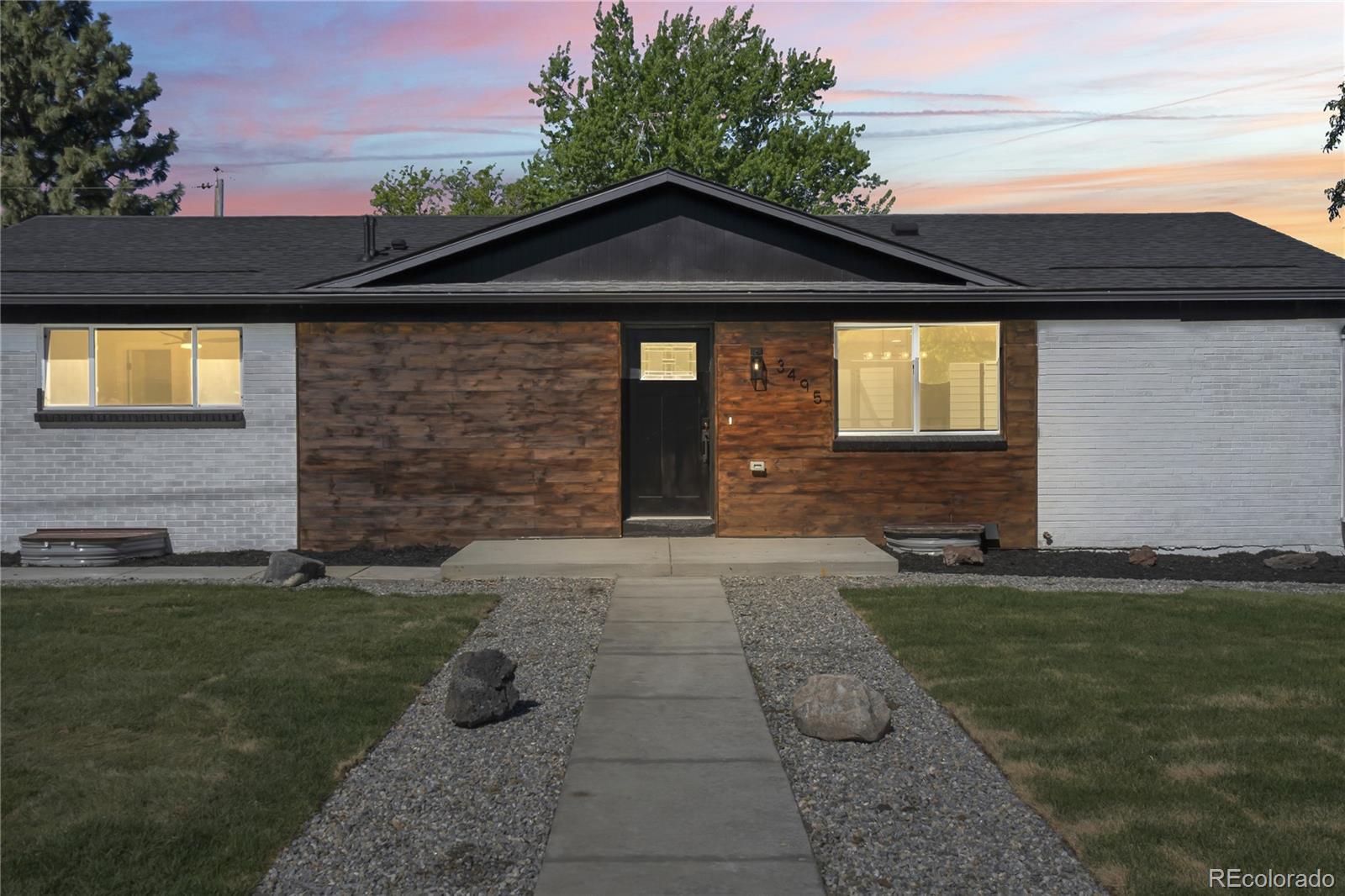 3495 Miller Street Wheat Ridge, CO 80033 - Photo 2 of 40 a front view of a house with garden