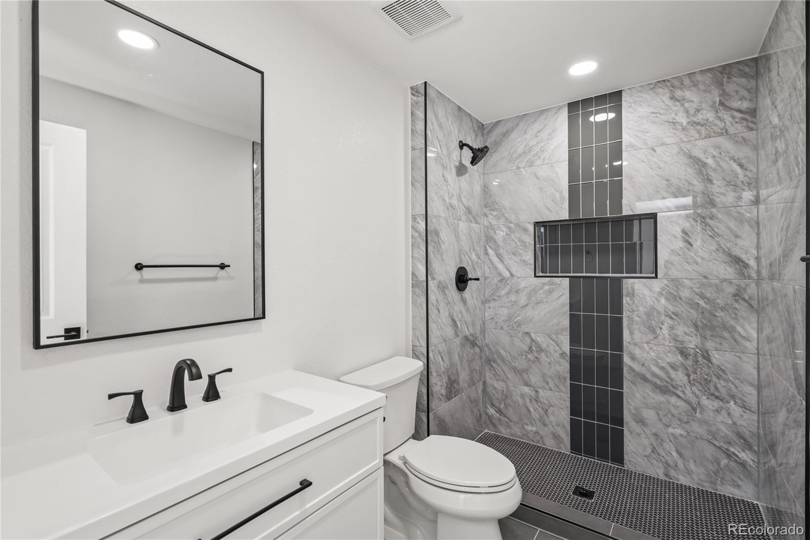 3495 Miller Street Wheat Ridge, CO 80033 - Photo 21 of 40 a bathroom with a sink a toilet and shower