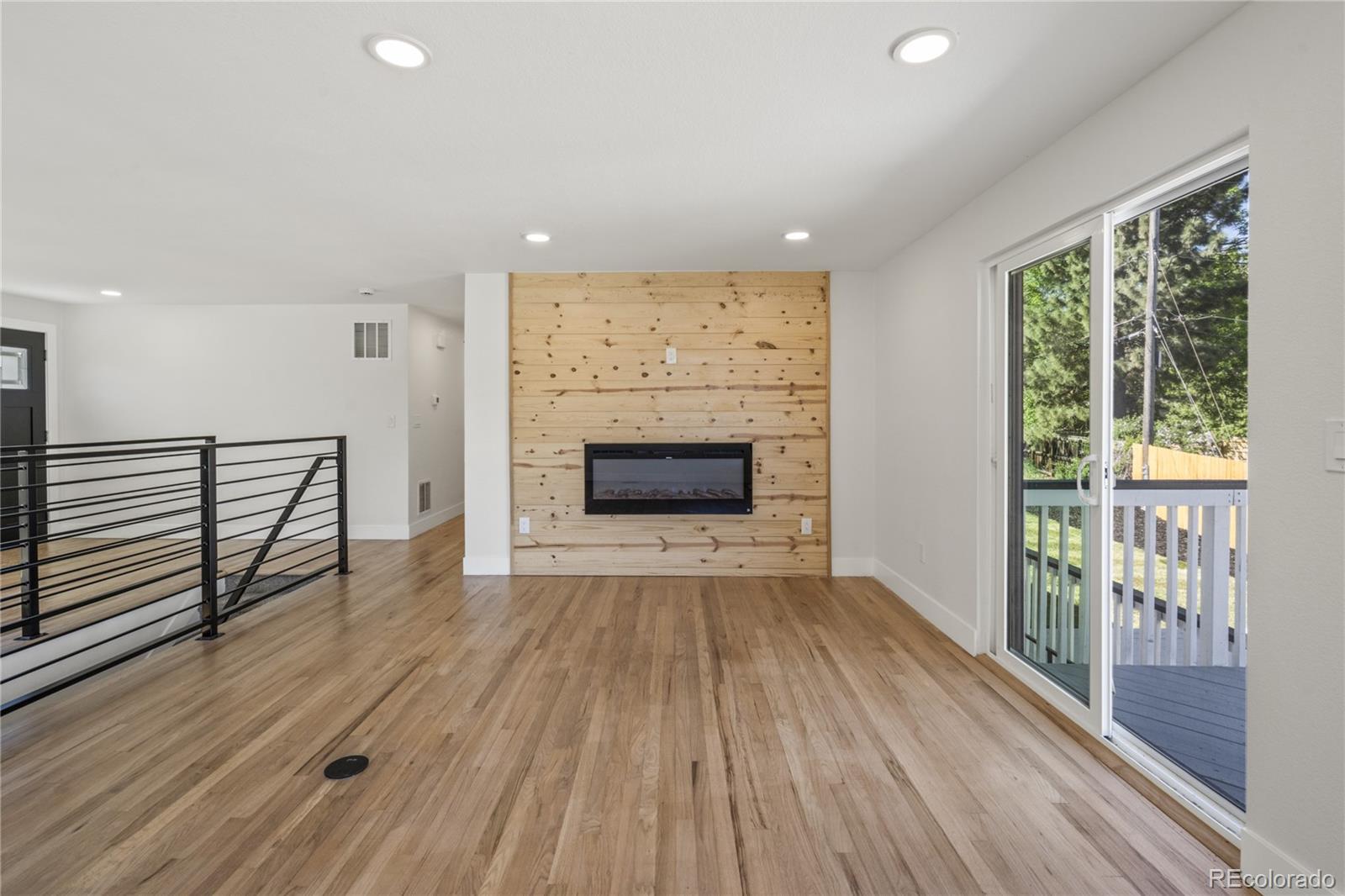3495 Miller Street Wheat Ridge, CO 80033 - Photo 31 of 40 wooden floor in an empty room with a fireplace