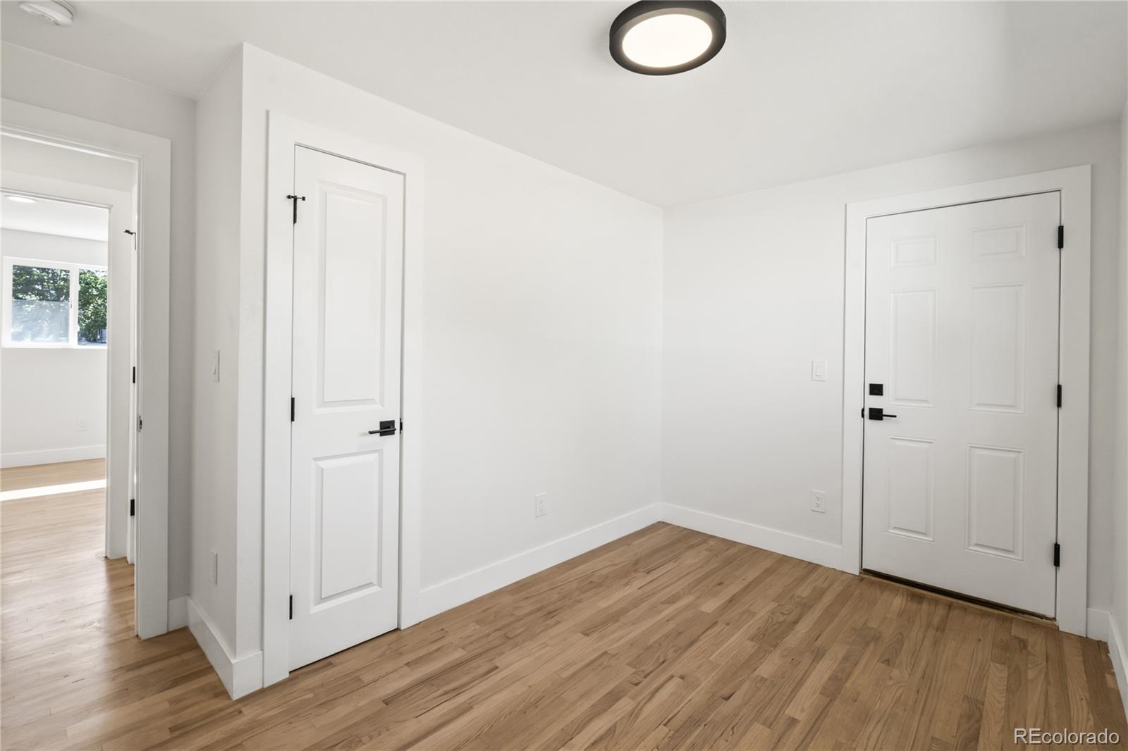 3495 Miller Street Wheat Ridge, CO 80033 - Photo 32 of 40 a view of empty room with wooden floor