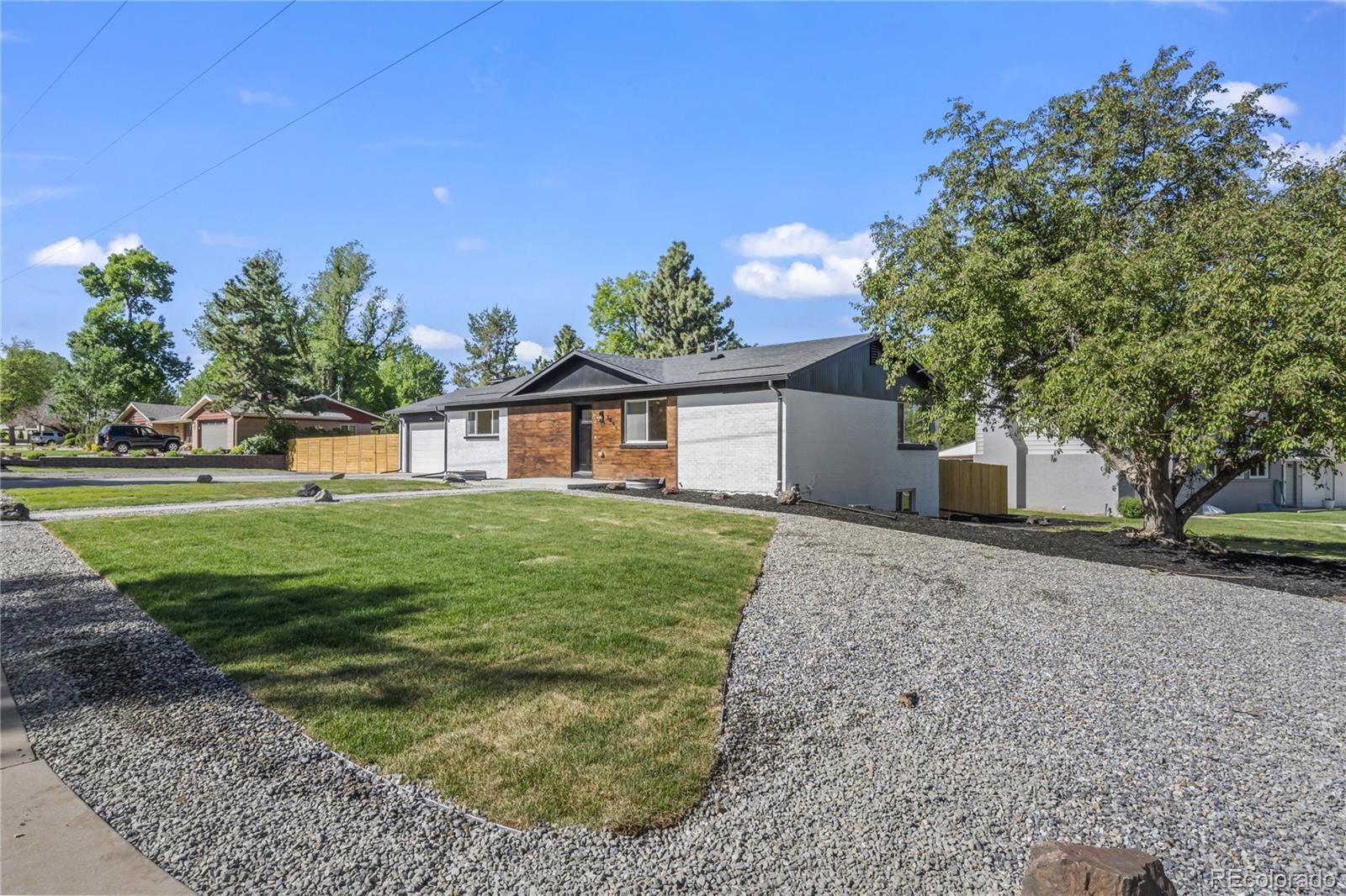 3495 Miller Street Wheat Ridge, CO 80033 - Photo 38 of 40 a front view of a house with a yard