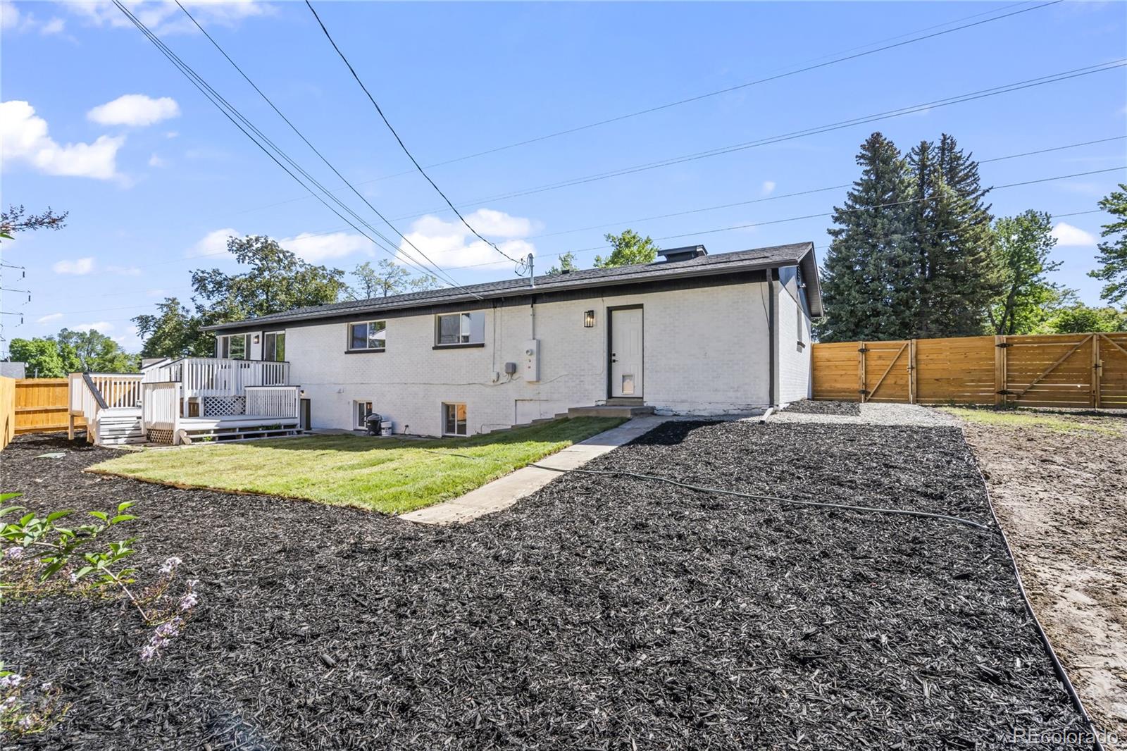 3495 Miller Street Wheat Ridge, CO 80033 - Photo 39 of 40 a backyard of a house with a garden and barbeque oven