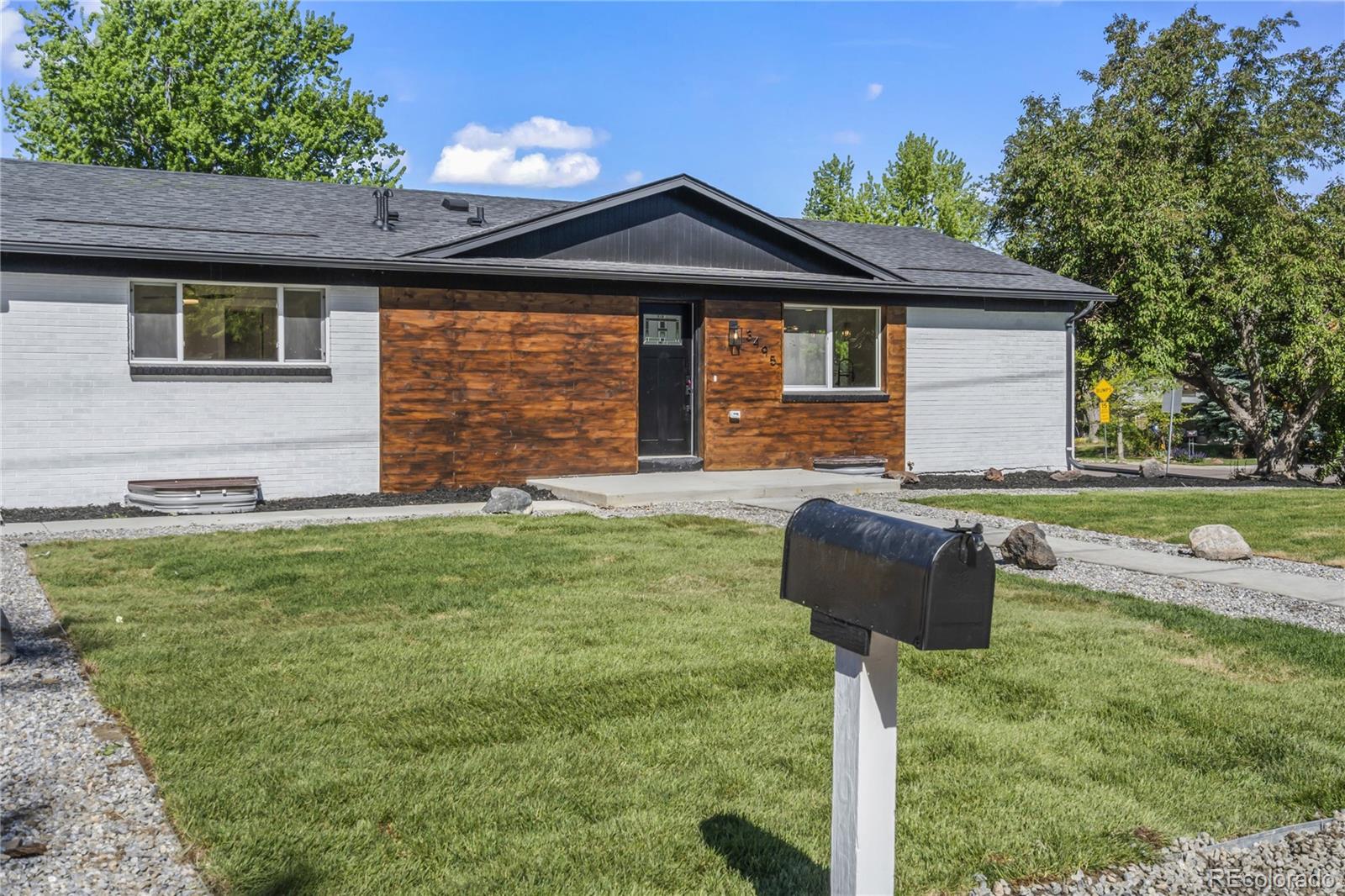 3495 Miller Street Wheat Ridge, CO 80033 - Photo 4 of 40 a front view of a house with garden
