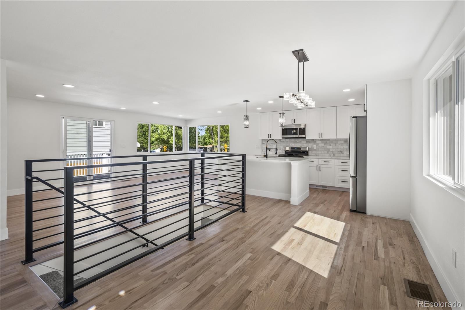 3495 Miller Street Wheat Ridge, CO 80033 - Photo 5 of 40 a kitchen with stainless steel appliances granite countertop a stove top oven a sink dishwasher and a refrigerator
