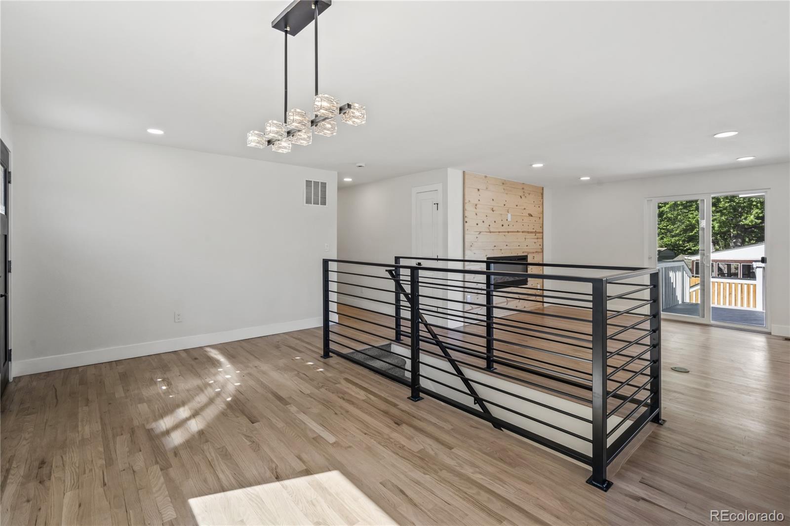 3495 Miller Street Wheat Ridge, CO 80033 - Photo 7 of 40 a view of a livingroom with hardwood floor and a ceiling fan
