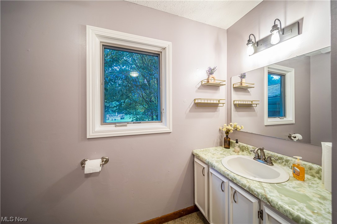 7585 Middle Ridge Road Madison, OH 44057 - Photo 6 of 35 Bathroom featuring vanity with extensive cabinet space