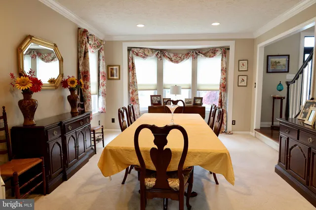 a living room with furniture fireplace and a large window