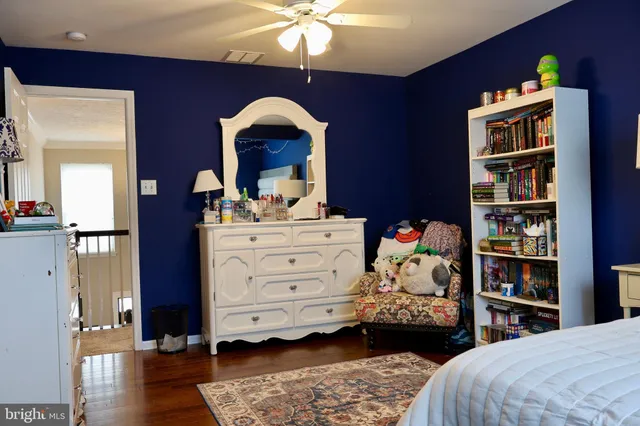 a bedroom with a bed and a bookshelf
