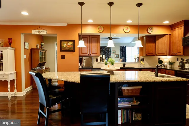 a kitchen with a dining table chairs sink and cabinets