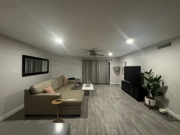 a living room with furniture and a flat screen tv