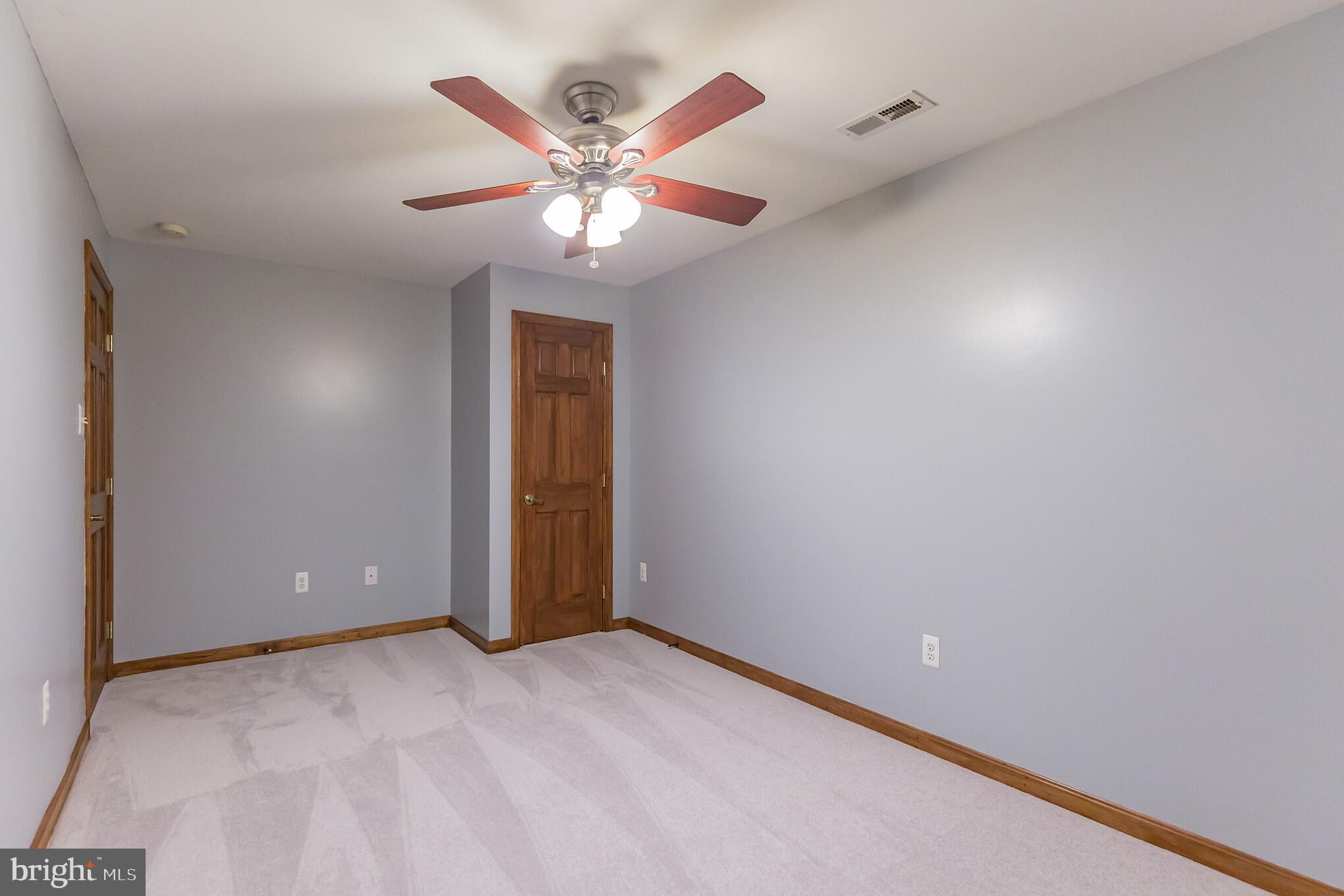 2750 Dalrymple Road Sunderland, MD 20689 - Photo 24 of 28 an empty room with a chandelier fan and windows
