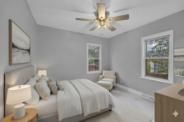 a bedroom with a bed and a chandelier