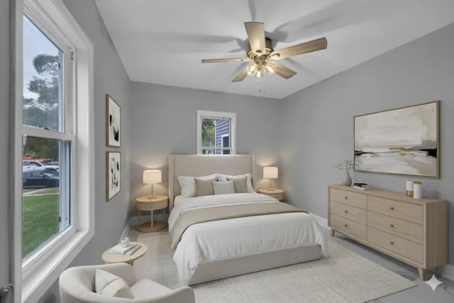 a bedroom with a bed and ceiling fan