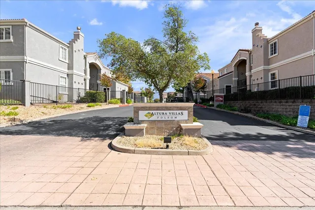 a view of a house with a fountain and a fire pit