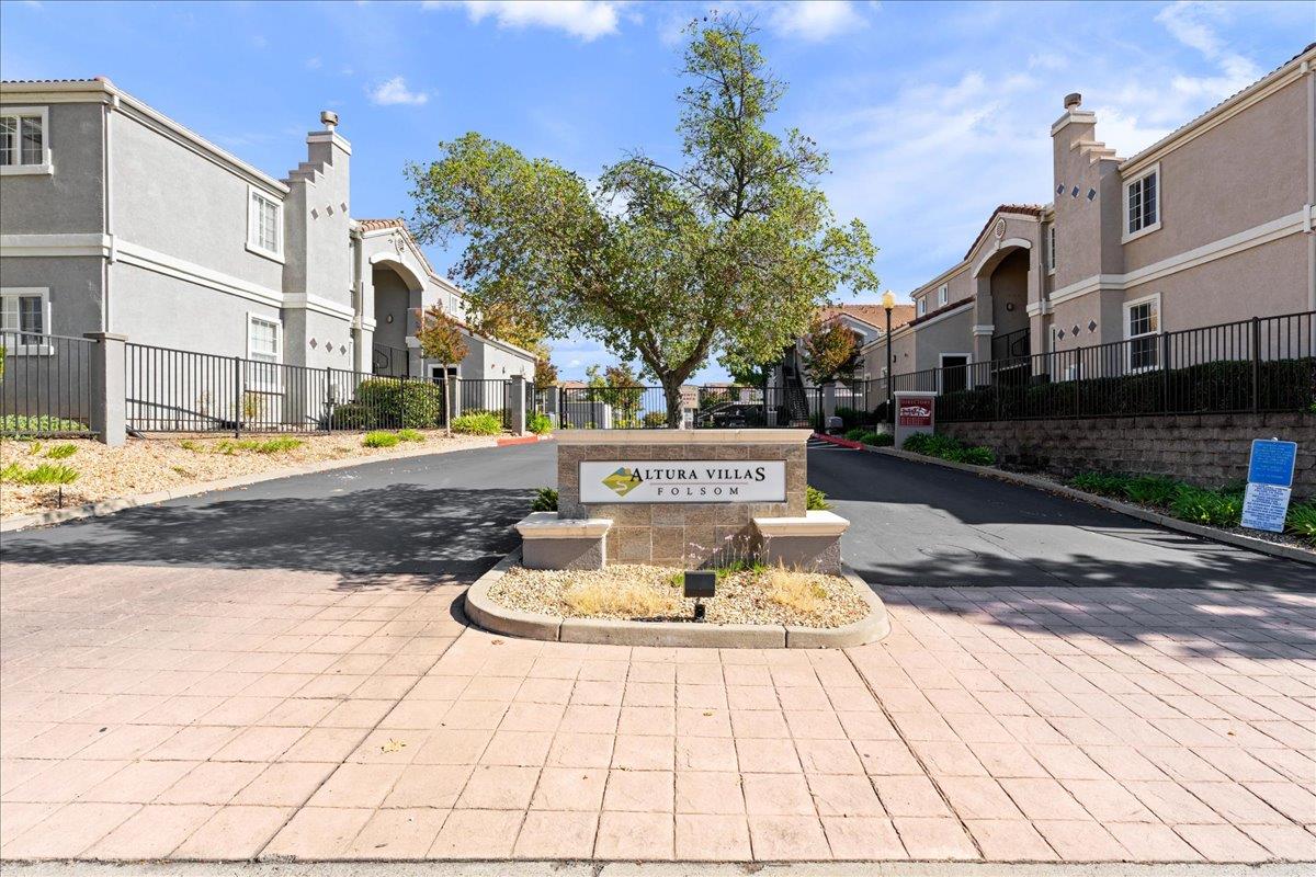 a view of a house with a fountain and a fire pit