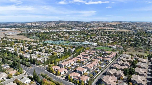 an aerial view of a house with a garden and lake view