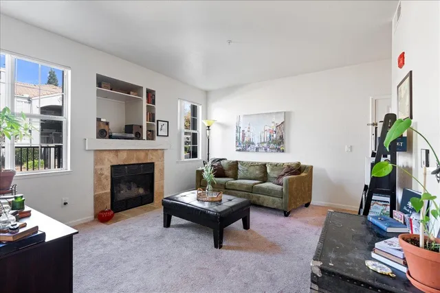 a living room with furniture and a fireplace