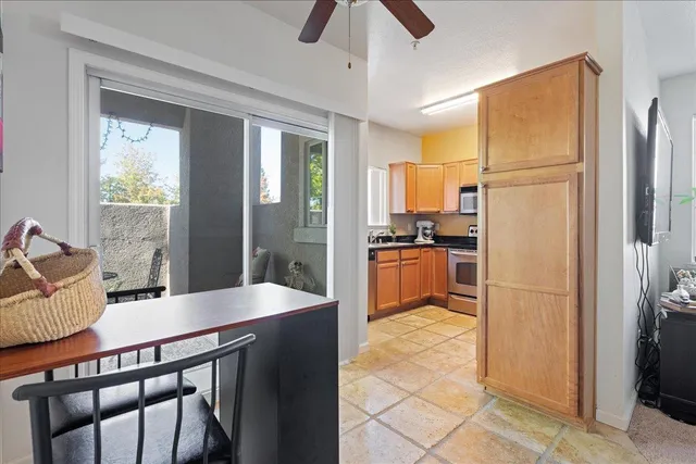 a kitchen with stainless steel appliances granite countertop a refrigerator a sink and white cabinets