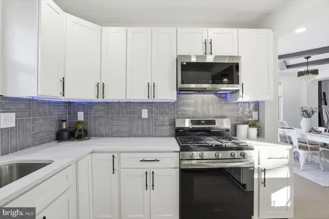 a kitchen with a stove and a white cabinets
